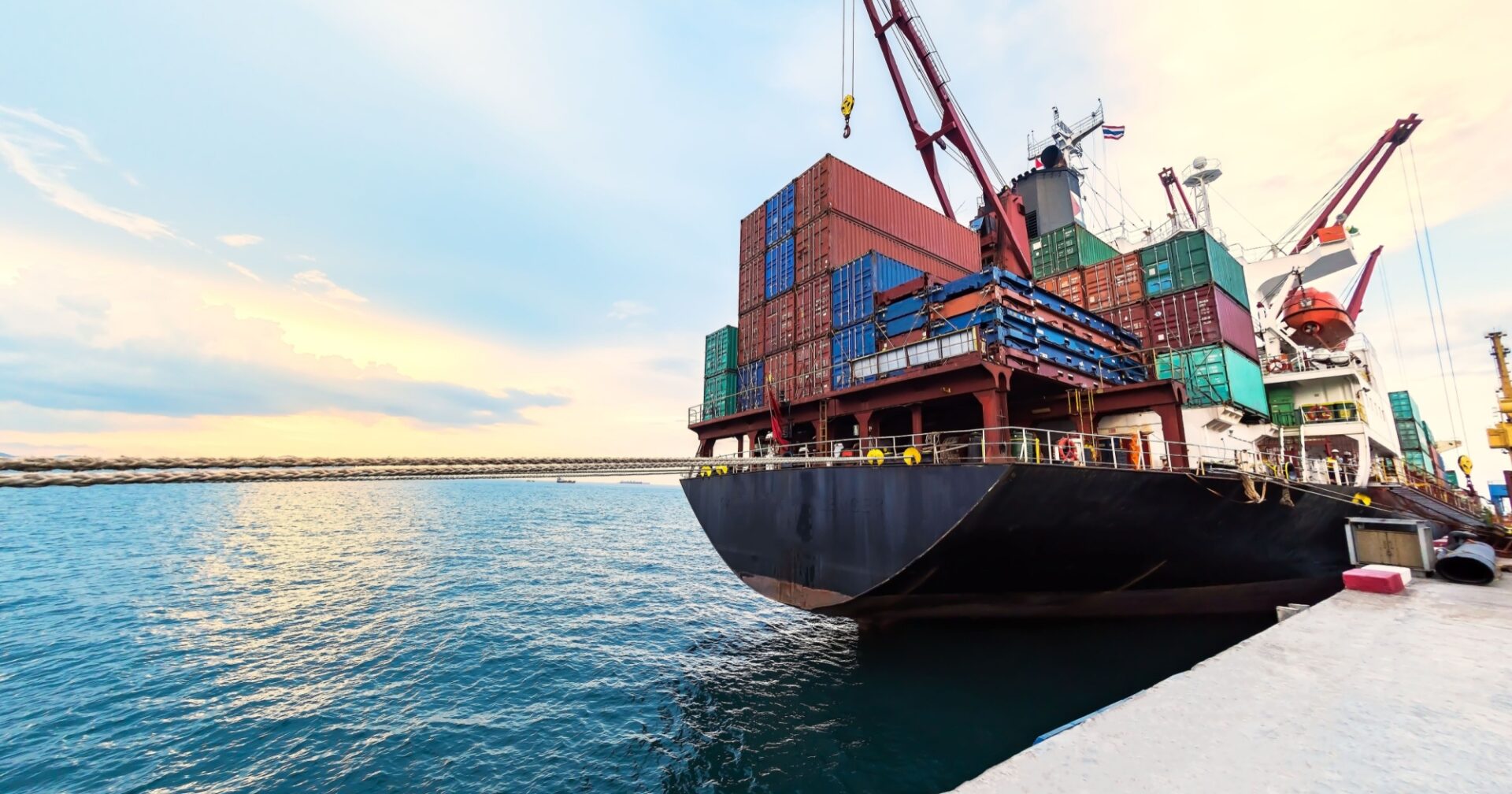 Commercial container ship in port delivering containers of goods.